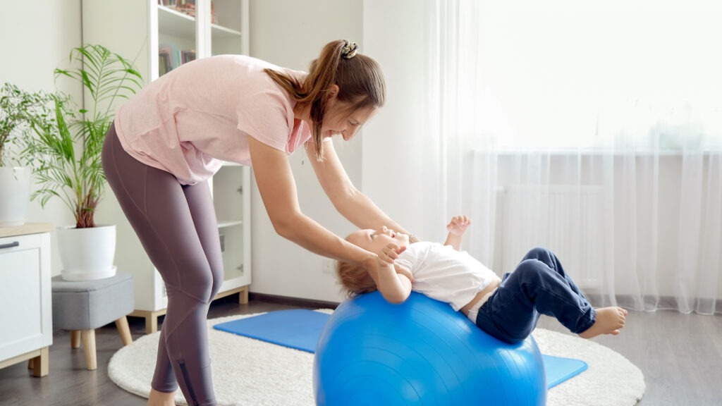 happy smiling baby boy rolling on blue fitness bal 2023 11 27 05 12 59 utc